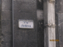 Judeca street sign obscured by downspout